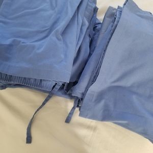 3 sets of blue Amazon Essentials scrubs